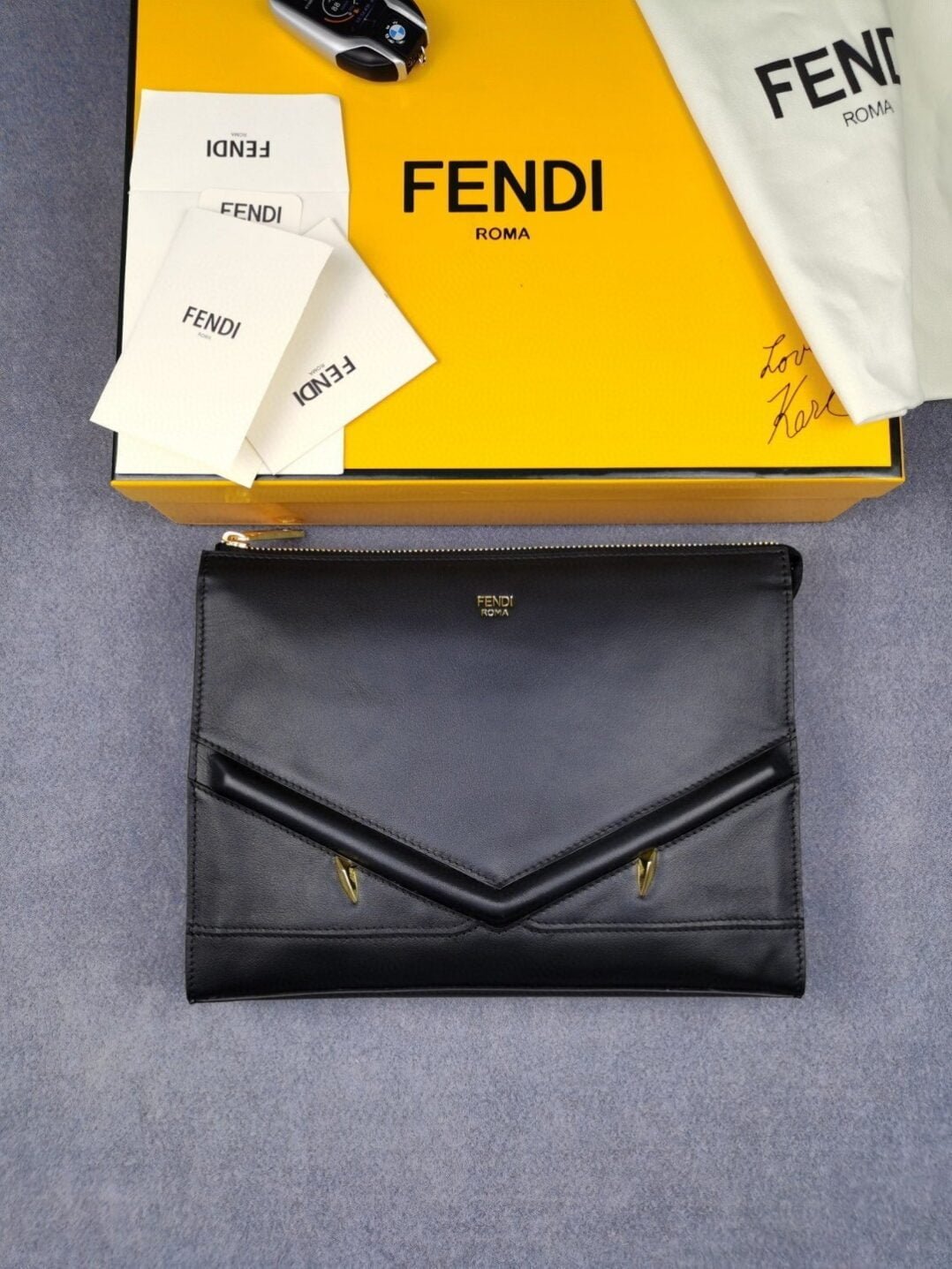 fendi-flat-zip-pouch-in-black-with-gold-toned-metalware-for-men-27cm105in-ff-dvjen-e1706732886493